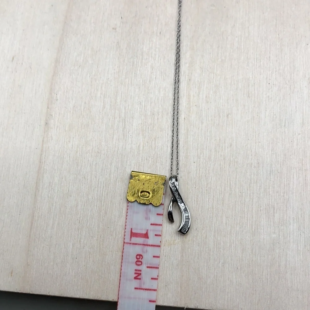 Solid 10k white gold multi baguette diamond wishbone pendant necklace.